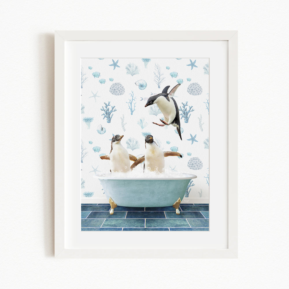 A framed image depicting two penguins sitting in a bathtub, with one penguin jumping out of the tub.
