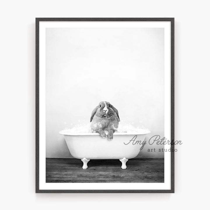 a black and white photo of a rabbit in a bathtub