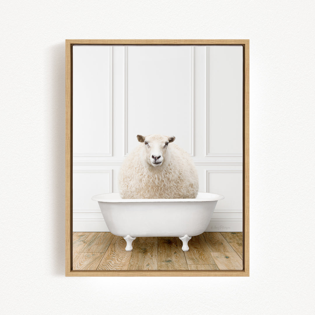 A fluffy white sheep sits in a white bathtub, creating a whimsical and charming scene.