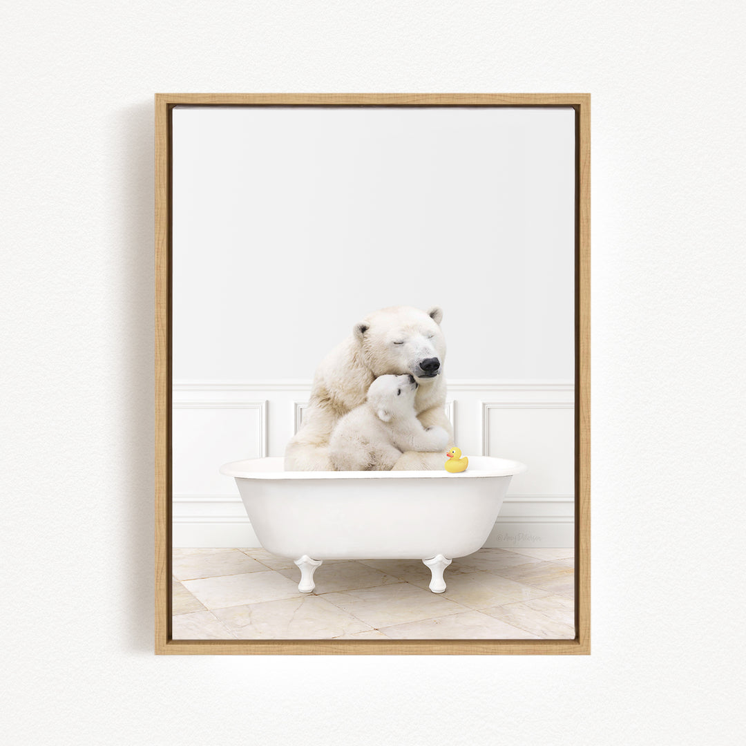 A framed image depicting two polar bears sitting in a white bathtub, with a yellow rubber duck floating in the water.