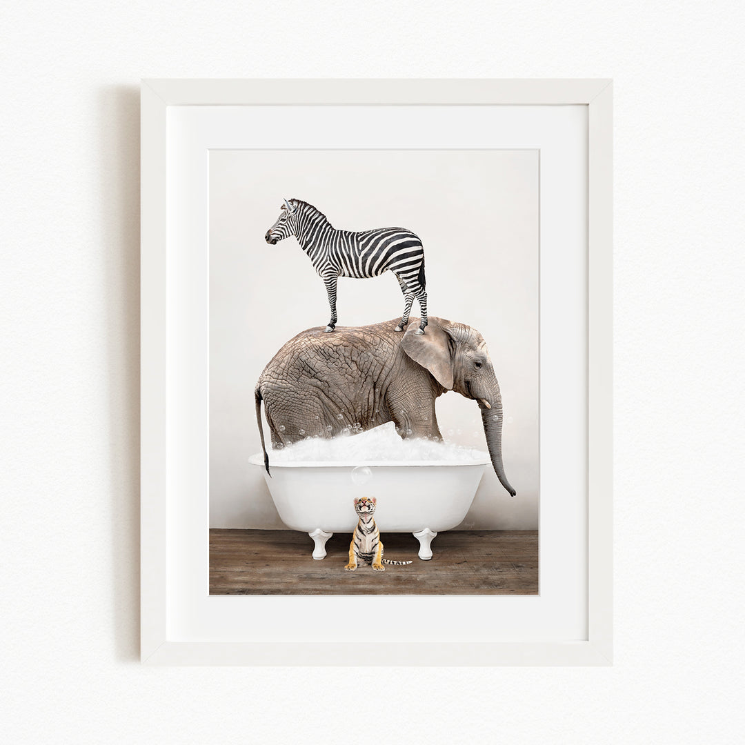 A zebra stands on top of an elephant in a bathtub, with a small tiger sitting on the edge of the tub.