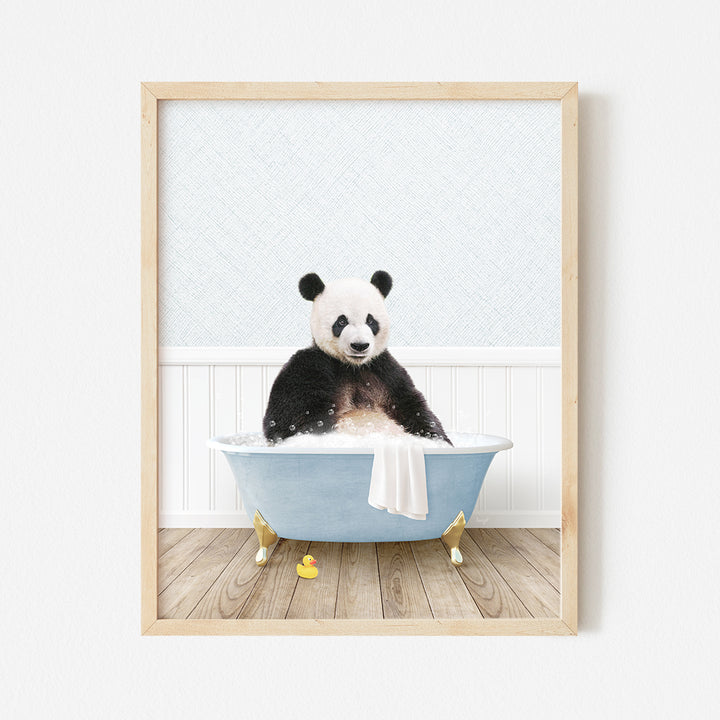 a panda bear sitting in a blue bath tub