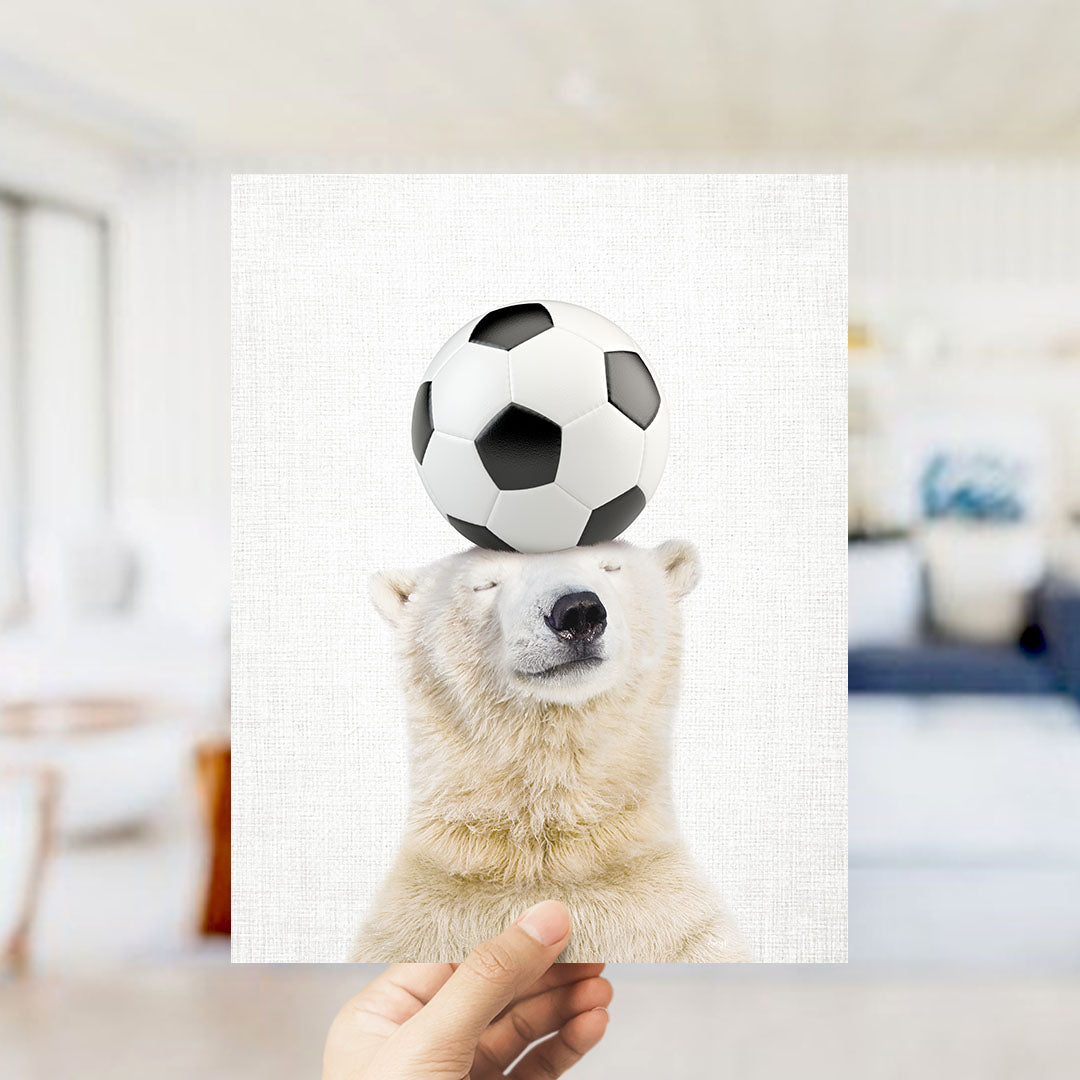 A polar bear balancing a soccer ball on its head.