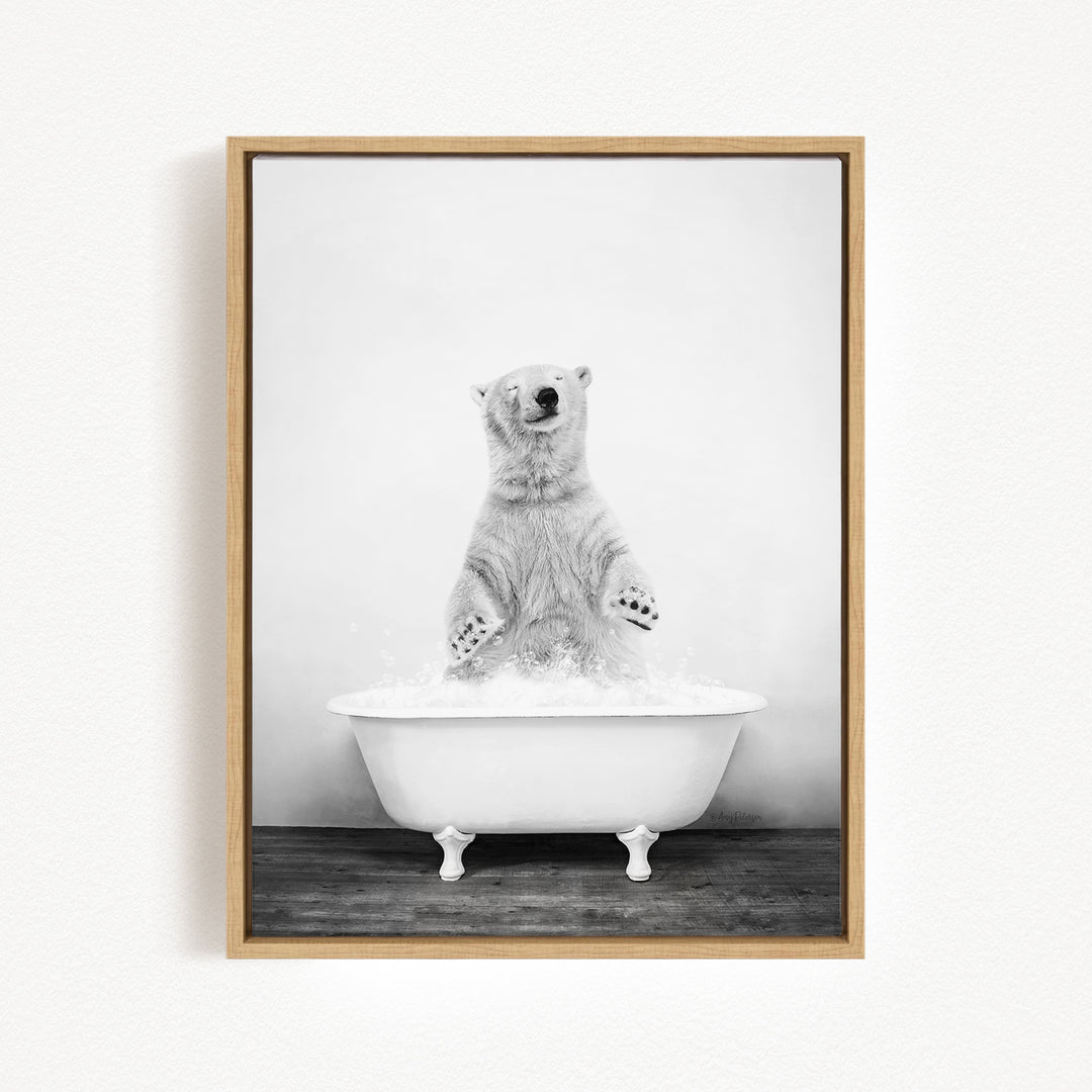 A polar bear standing in a white bathtub filled with water, appearing to be enjoying a bath.