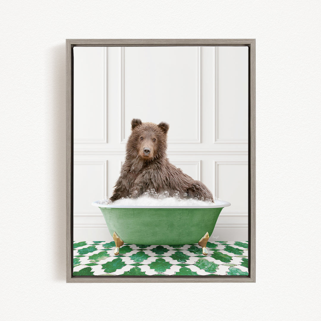 A brown bear sitting in a green bathtub filled with bubbles, with a patterned green and white rug on the floor.