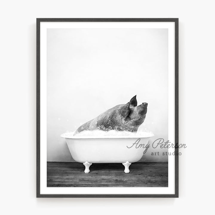 a black and white photo of a dog taking a bath