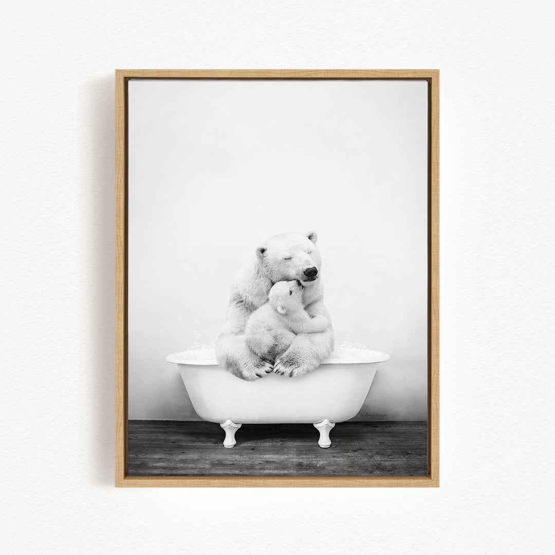 A black and white photograph of a mother polar bear sitting in a bathtub, with her cub resting on her lap.