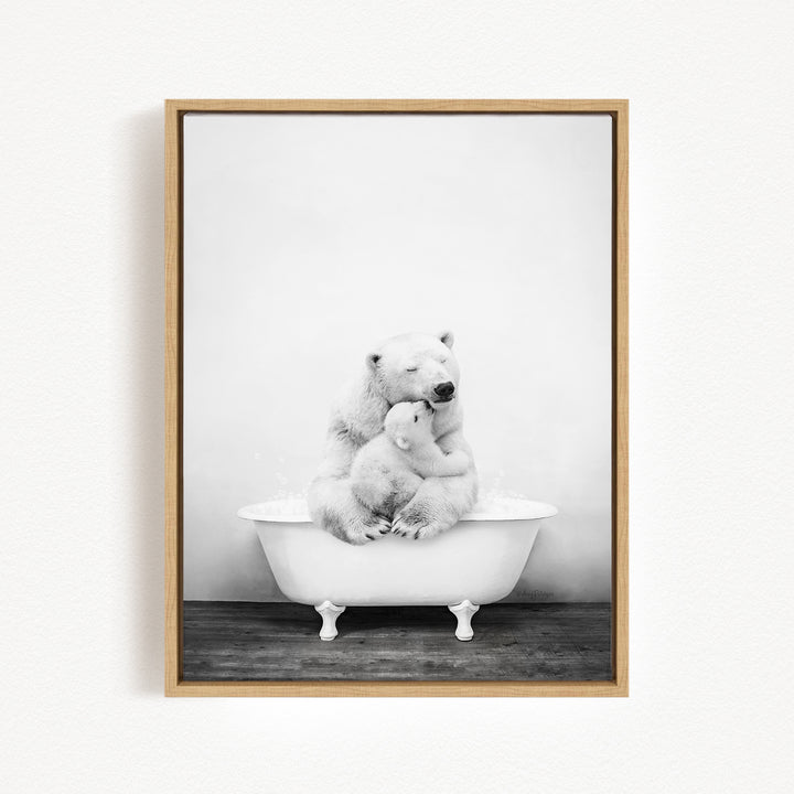 A black and white photograph of a mother polar bear sitting in a bathtub, with her cub resting on her lap.