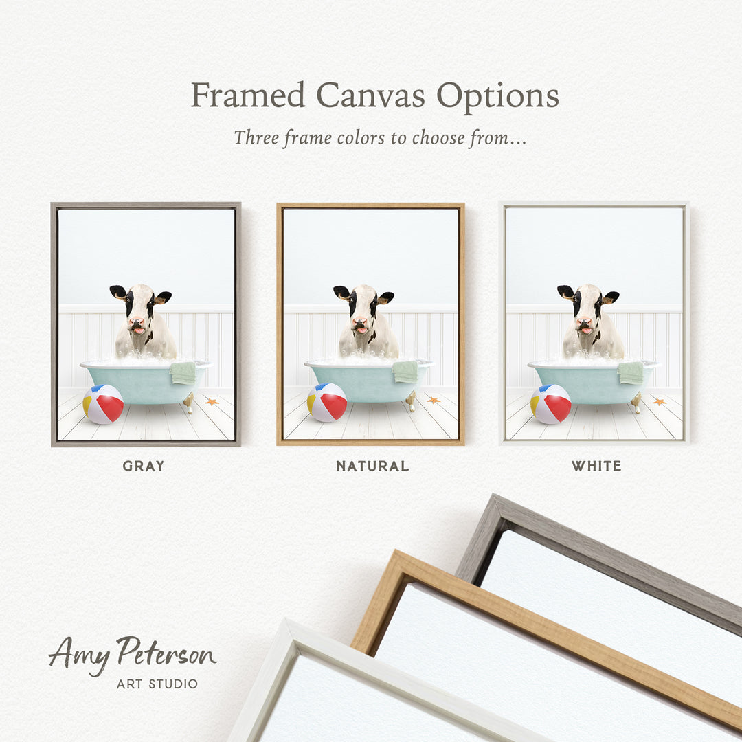 The image is a framed canvas option showcasing three different frame colors: gray, natural, and white. The canvas features a cow sitting in a bathtub with a beach ball and starfish nearby.