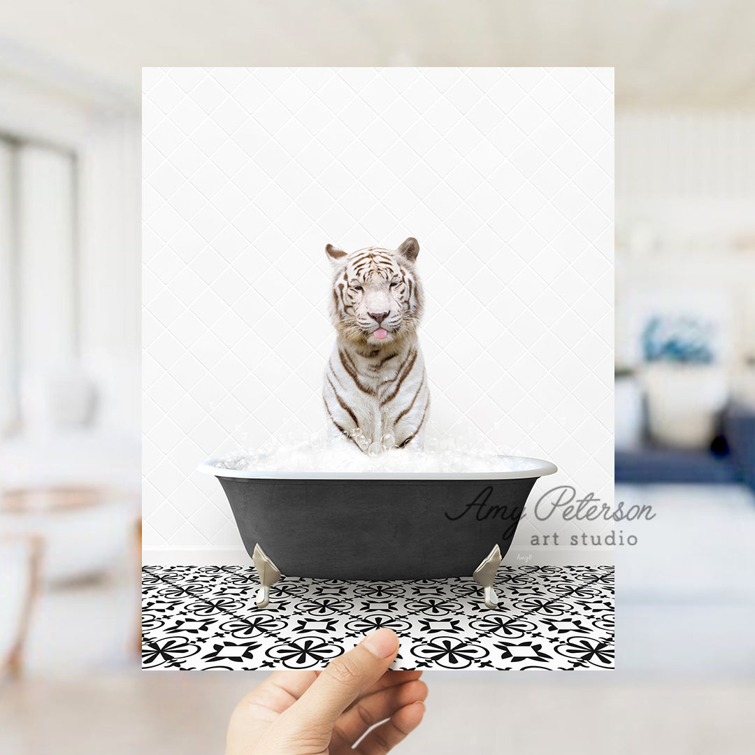 a white tiger sitting in a black bath tub