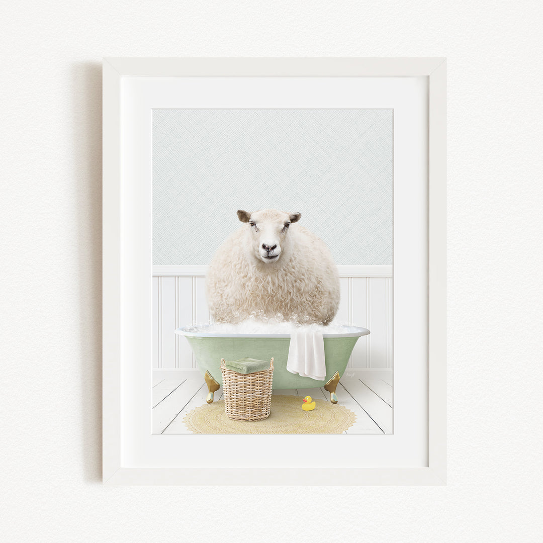 A fluffy white sheep sits in a green bathtub filled with bubbles, surrounded by a basket of bath toys and a yellow rubber duck.