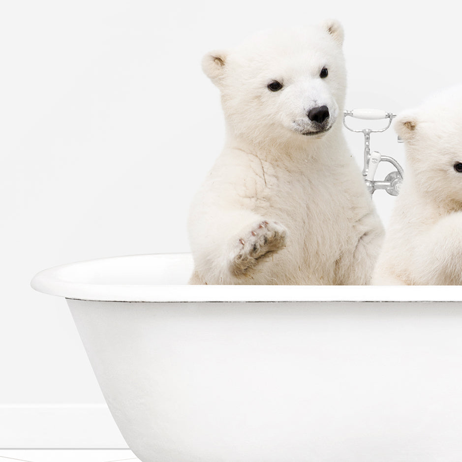 two polar bears are sitting in a bathtub