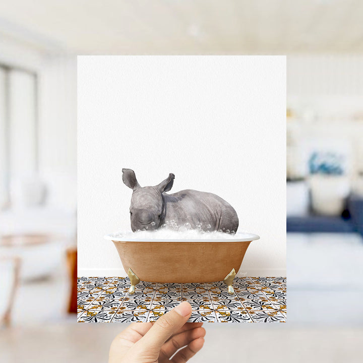 A rhinoceros is sitting in a bathtub filled with bubbles, creating a whimsical and playful scene.