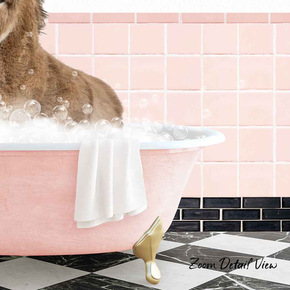 A brown dog sitting in a pink bathtub filled with bubbles, with a white towel hanging on the side and a pink tile wall in the background.