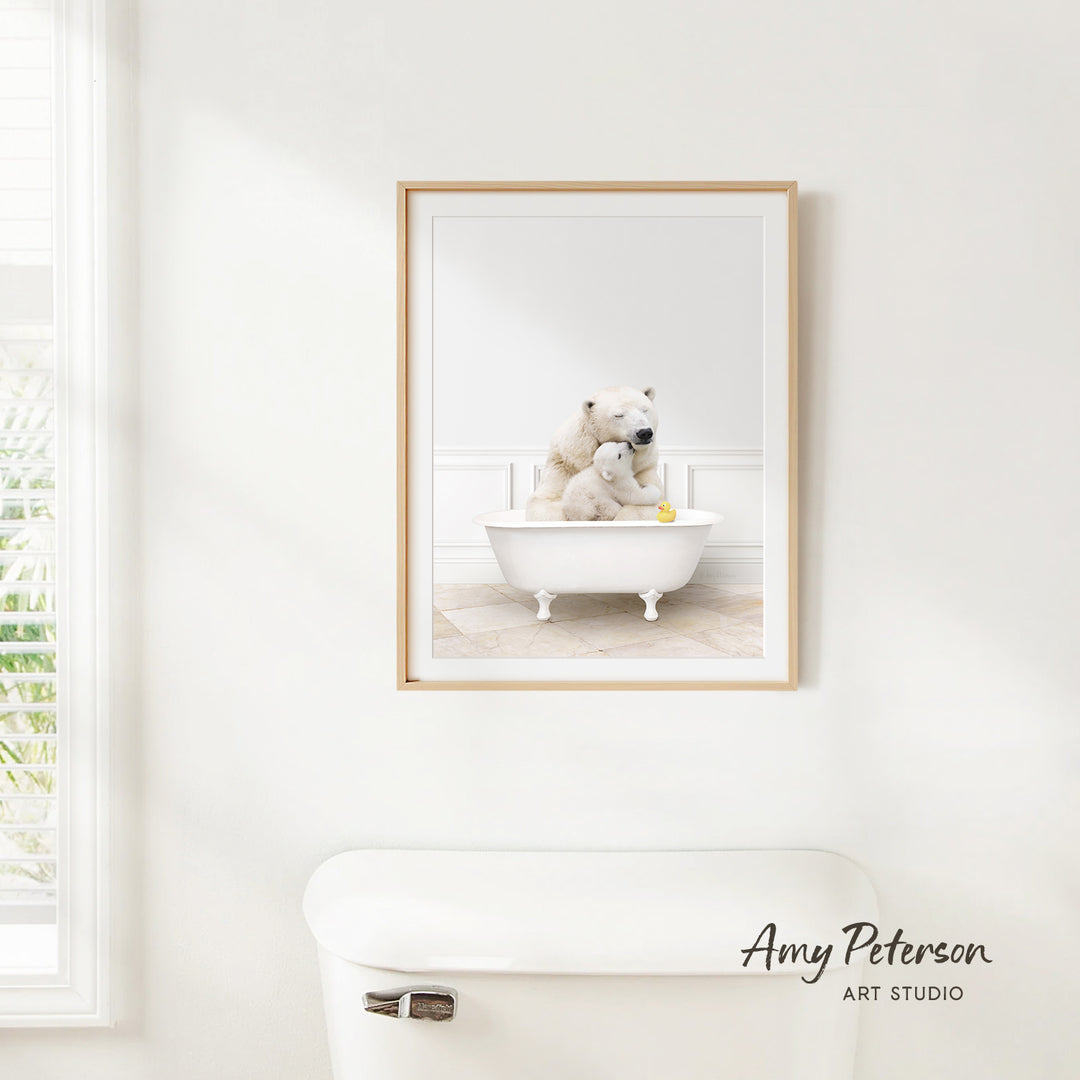 A framed image of two polar bears sitting in a bathtub, with one bear holding a yellow rubber duck.