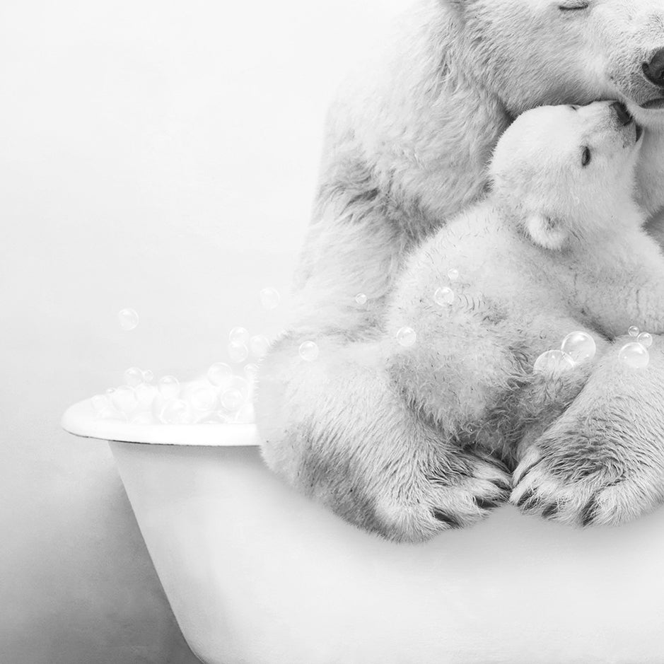 a black and white photo of a mother polar bear and her cub