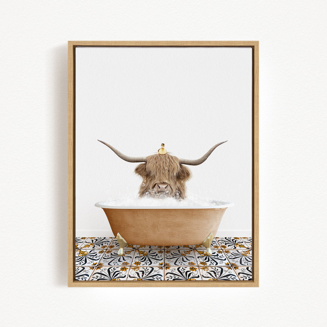 A brown cow with long horns is sitting in a bathtub filled with bubbles, with a small bird perched on its head.