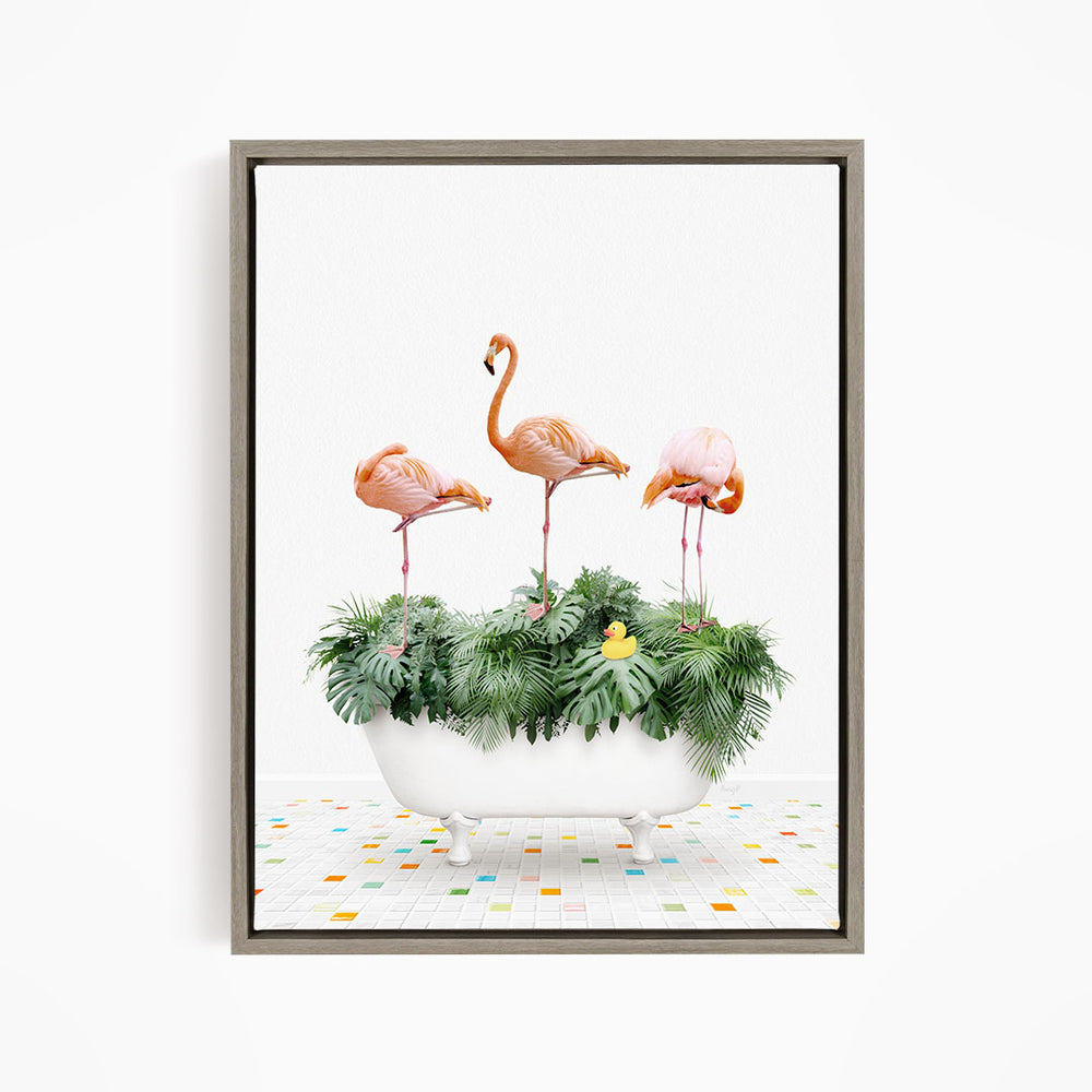 A framed image depicting three flamingos standing on a bathtub filled with green plants and a yellow rubber duck.