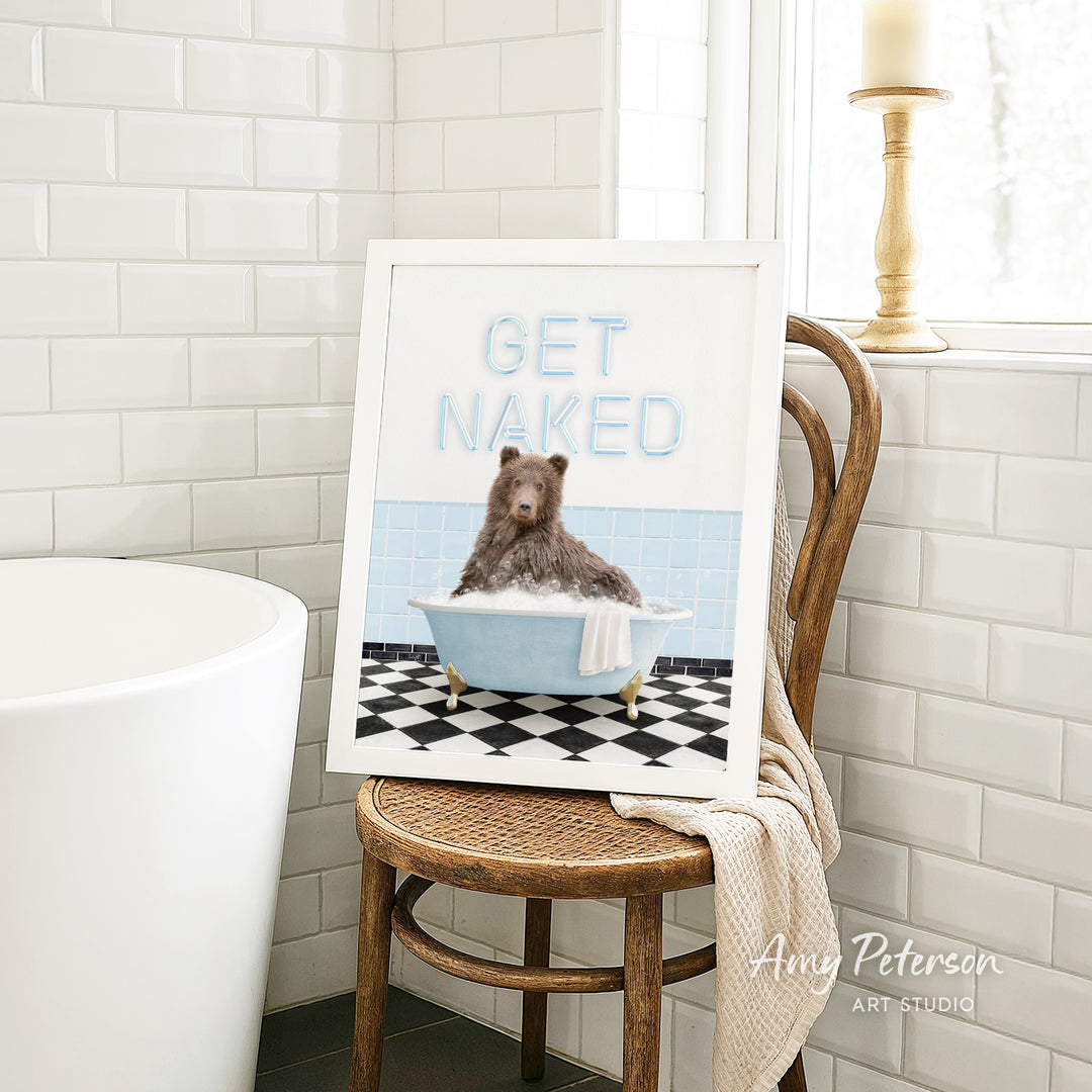 A framed image of a bear sitting in a bathtub, with the text "GET NAKED" displayed on the frame.