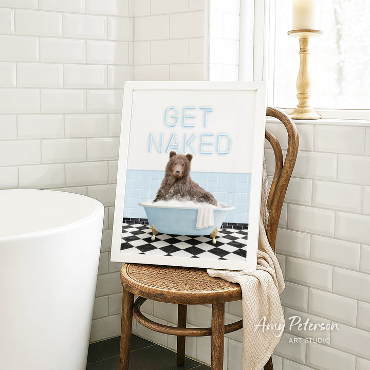 A framed image of a bear sitting in a bathtub, with the text "GET NAKED" displayed on the frame.
