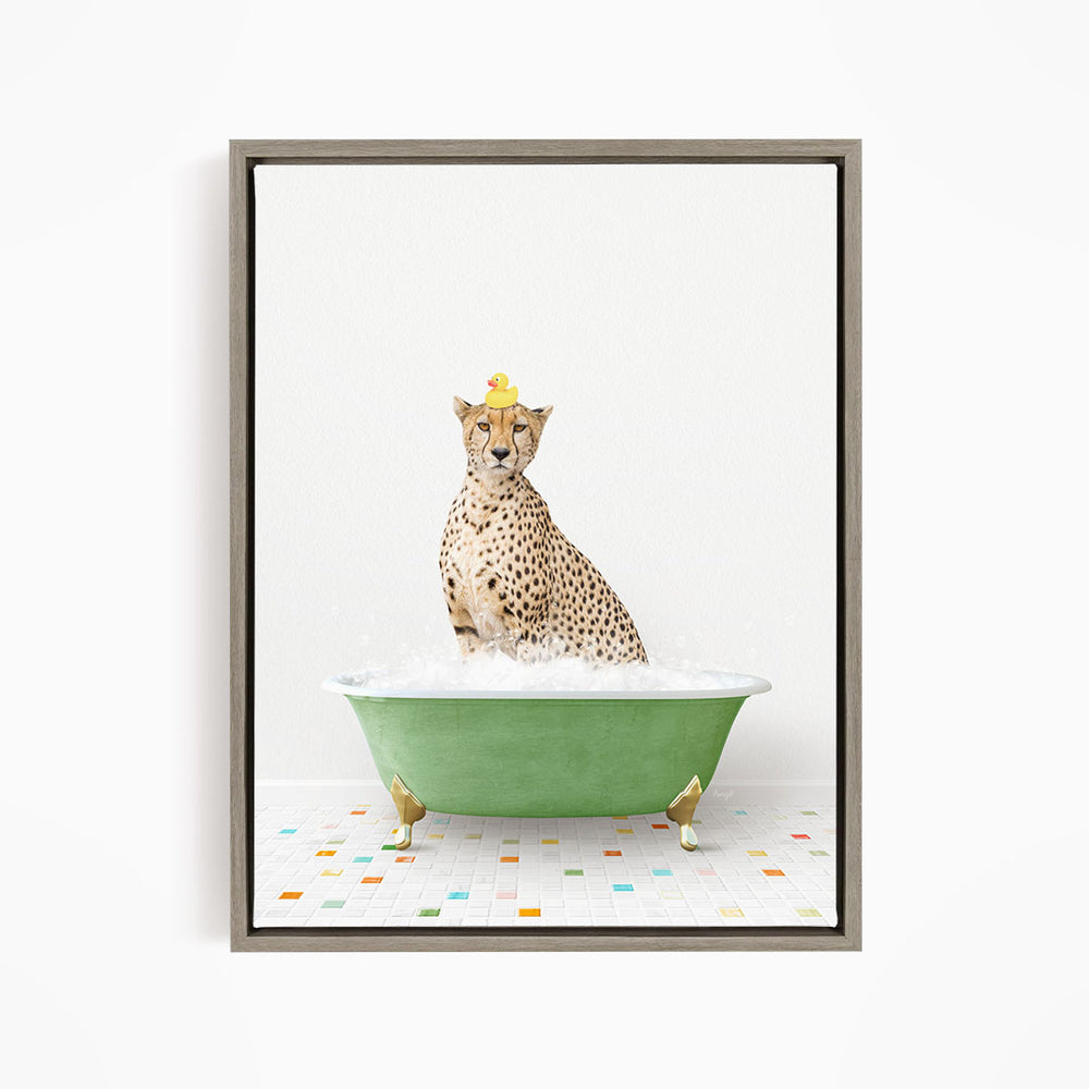 A cheetah sitting in a green bathtub filled with bubbles, wearing a yellow rubber duck hat.