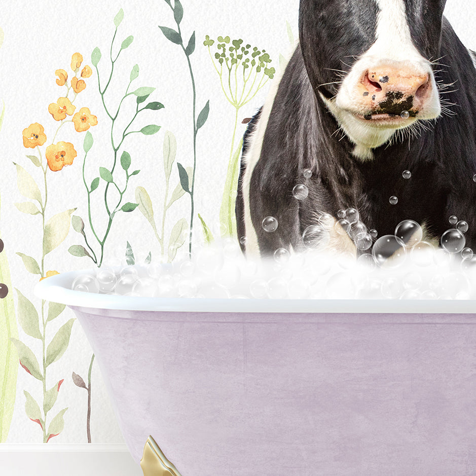 a black and white cow sitting in a bathtub filled with bubbles