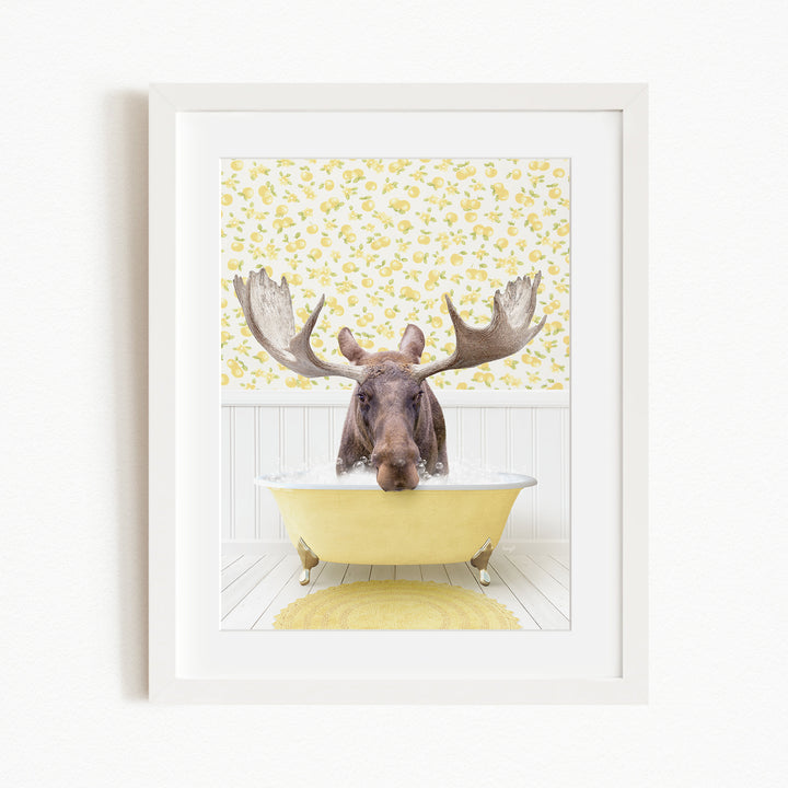A moose with large antlers is sitting in a yellow bathtub, surrounded by a yellow floral pattern on the wall behind it.