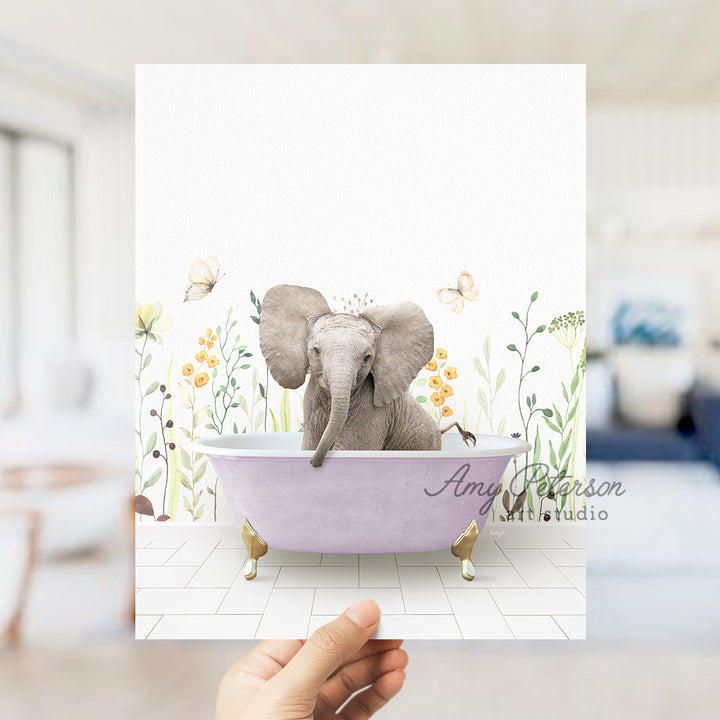 a person holding up a card with an elephant in a bathtub