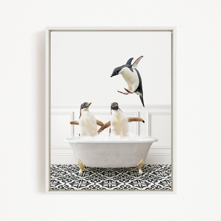 A framed image depicting two penguins sitting in a bathtub, with one penguin flying towards the other.