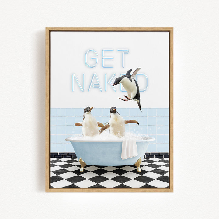 A framed image depicting three penguins sitting in a bathtub, with one penguin jumping out of the tub and the other two penguins sitting in the water. The text "GET NAKED" is displayed above the penguins.