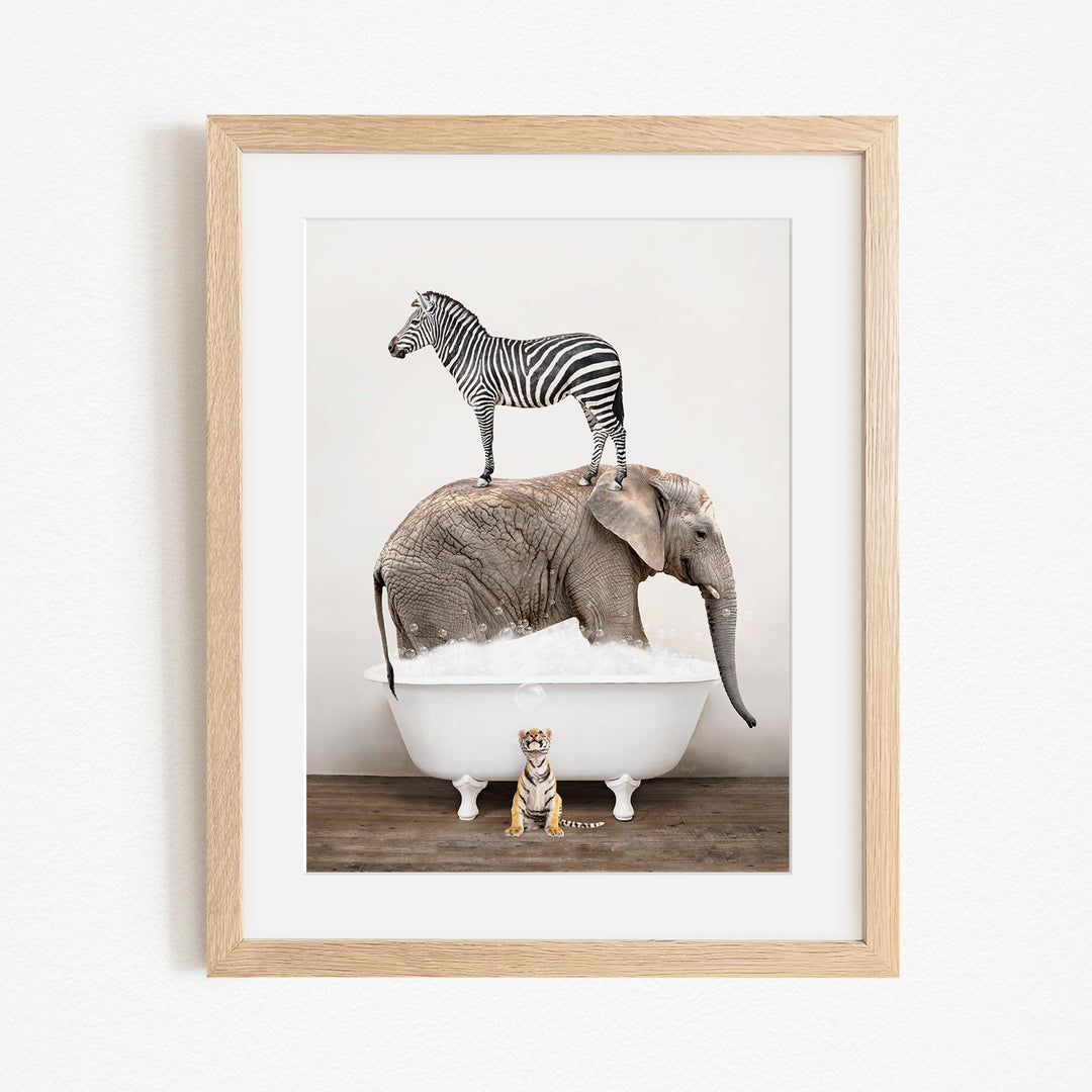 A zebra stands on top of an elephant in a bathtub, with a small tiger sitting on the edge of the tub.
