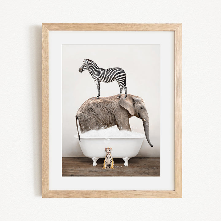 A zebra stands on top of an elephant in a bathtub, with a small tiger sitting on the edge of the tub.