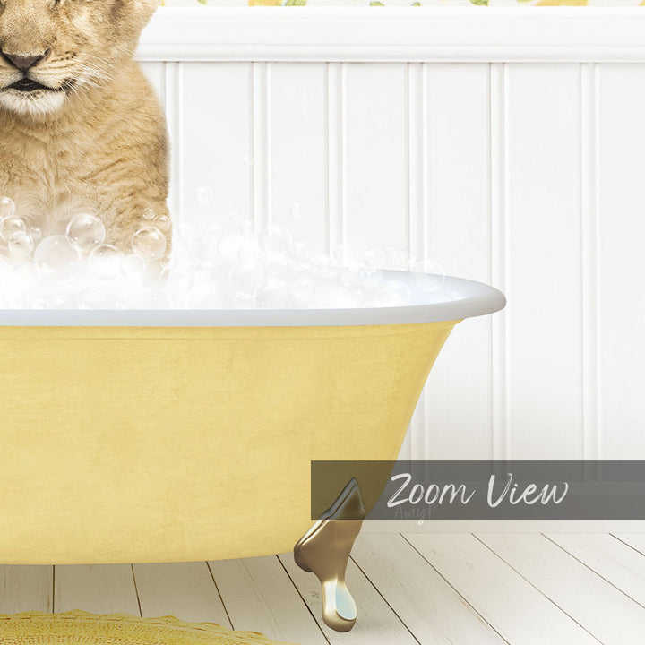 A cat sitting in a yellow bathtub filled with bubbles, with a white wall and wooden floor in the background.