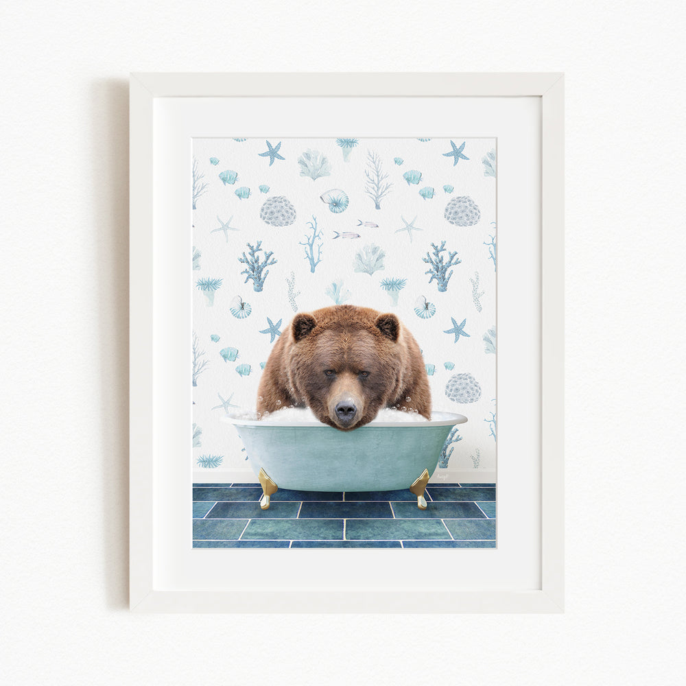A brown bear is sitting in a blue bathtub filled with bubbles, surrounded by a pattern of blue and white seashells and starfish.