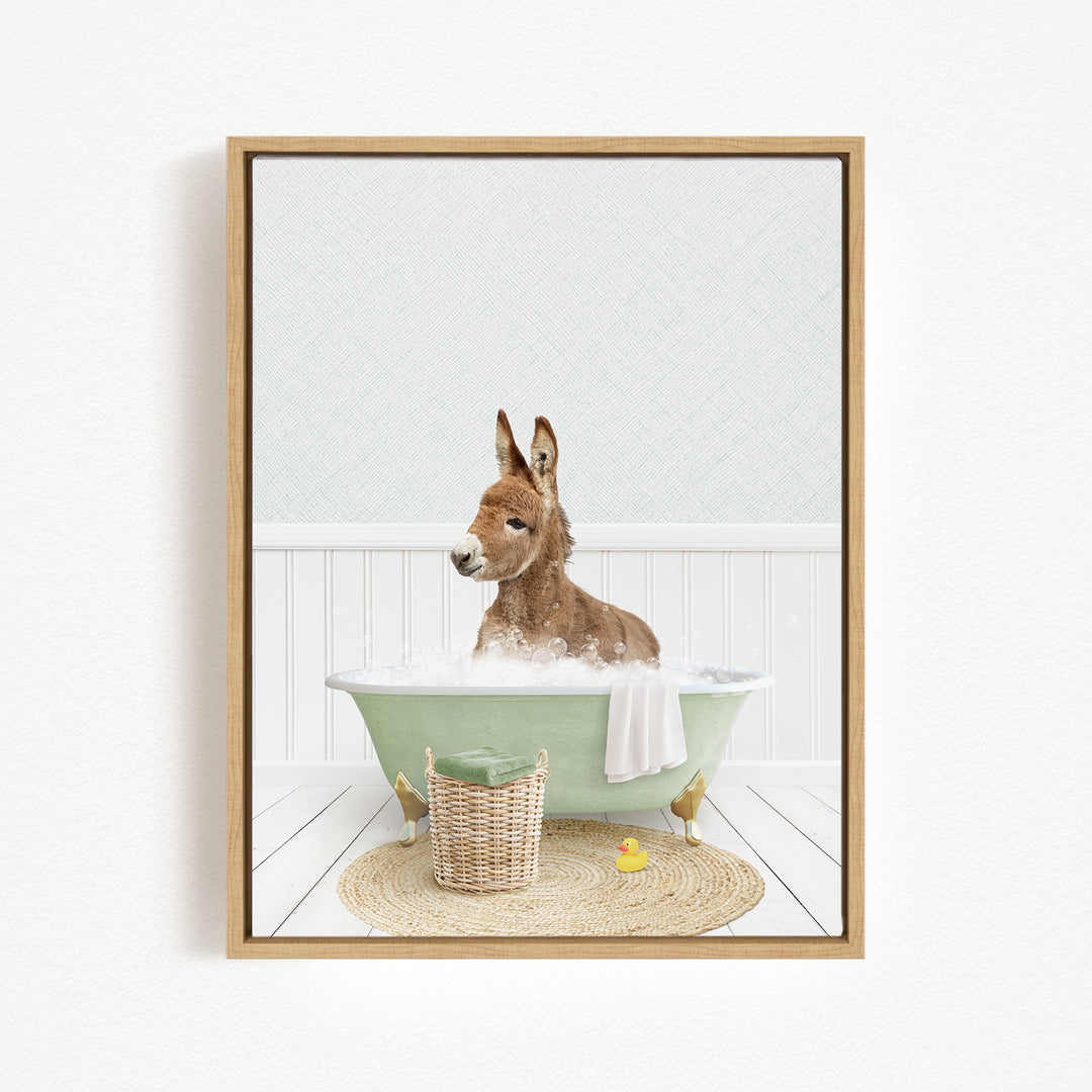 A donkey is sitting in a green bathtub filled with bubbles, surrounded by a basket of toys and a yellow rubber duck.