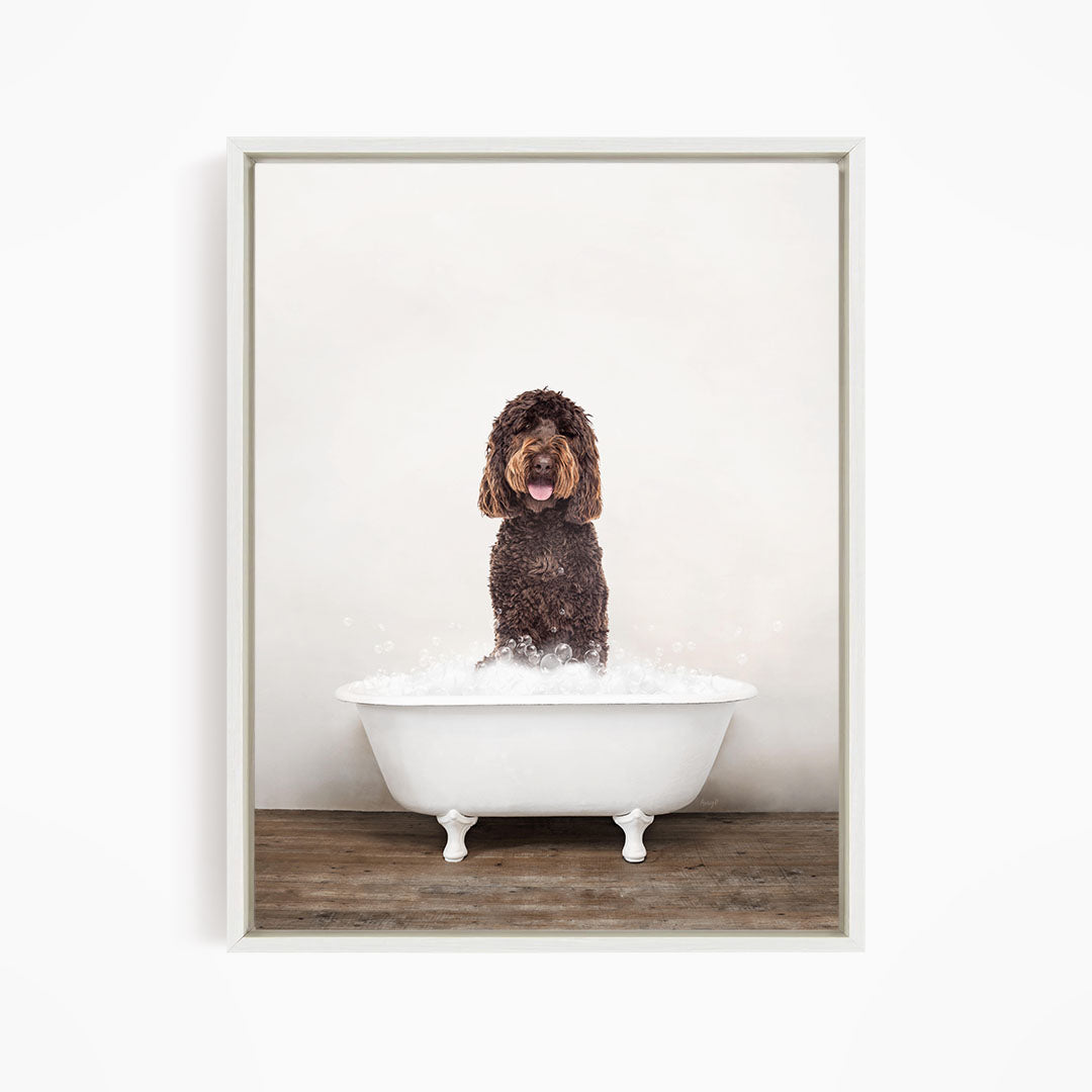A brown dog sitting in a white bathtub filled with water, with bubbles around it.
