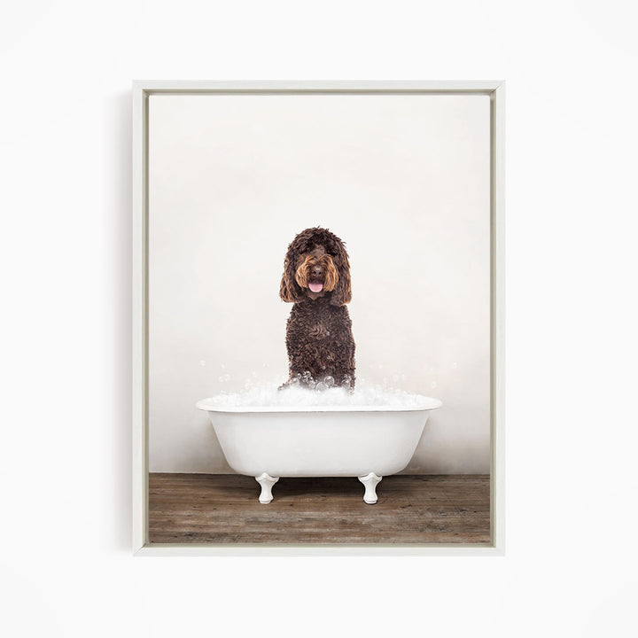 A brown dog sitting in a white bathtub filled with water, with bubbles around it.