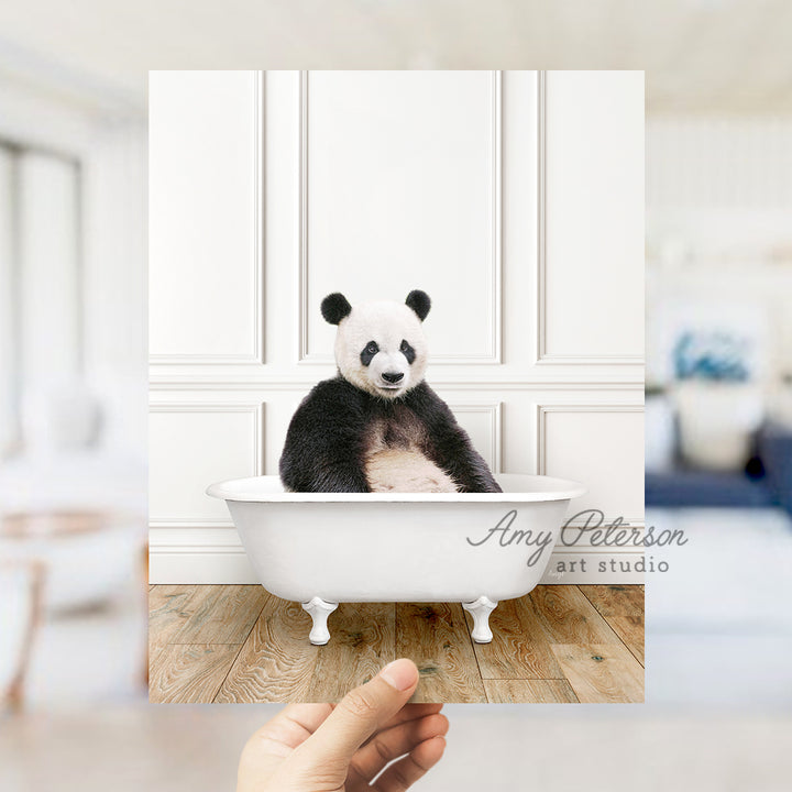 a panda bear sitting in a bath tub