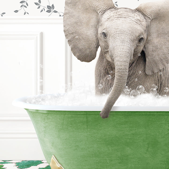 a baby elephant is taking a bath in a green tub