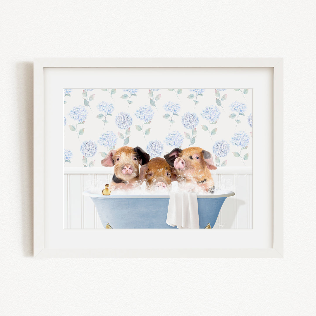 Three adorable pigs sitting in a blue bathtub, surrounded by a floral patterned background.