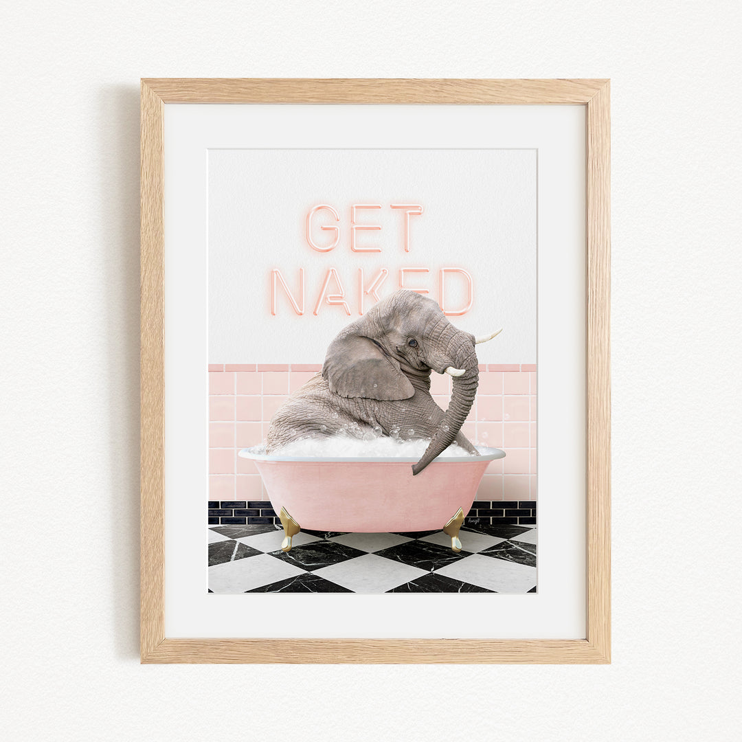 A framed image depicting a gray elephant sitting in a pink bathtub, with the text "GET NAKED" displayed above it.