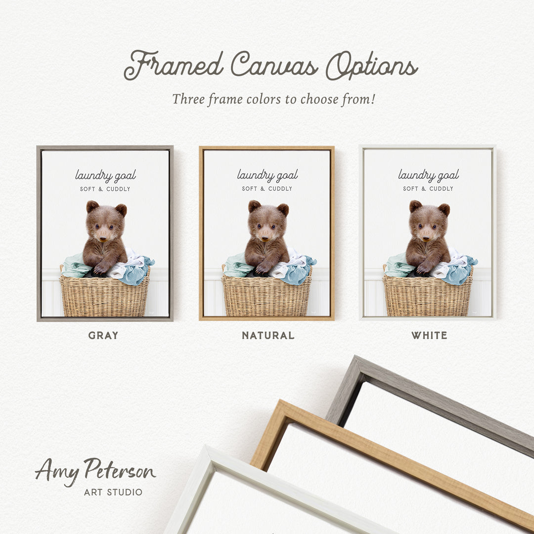 three framed canvas options, each featuring a teddy bear in a basket. The options include a gray frame, a natural frame, and a white frame. The text above the options reads "framed Canvas Options" and "Three frame colors to choose from!".