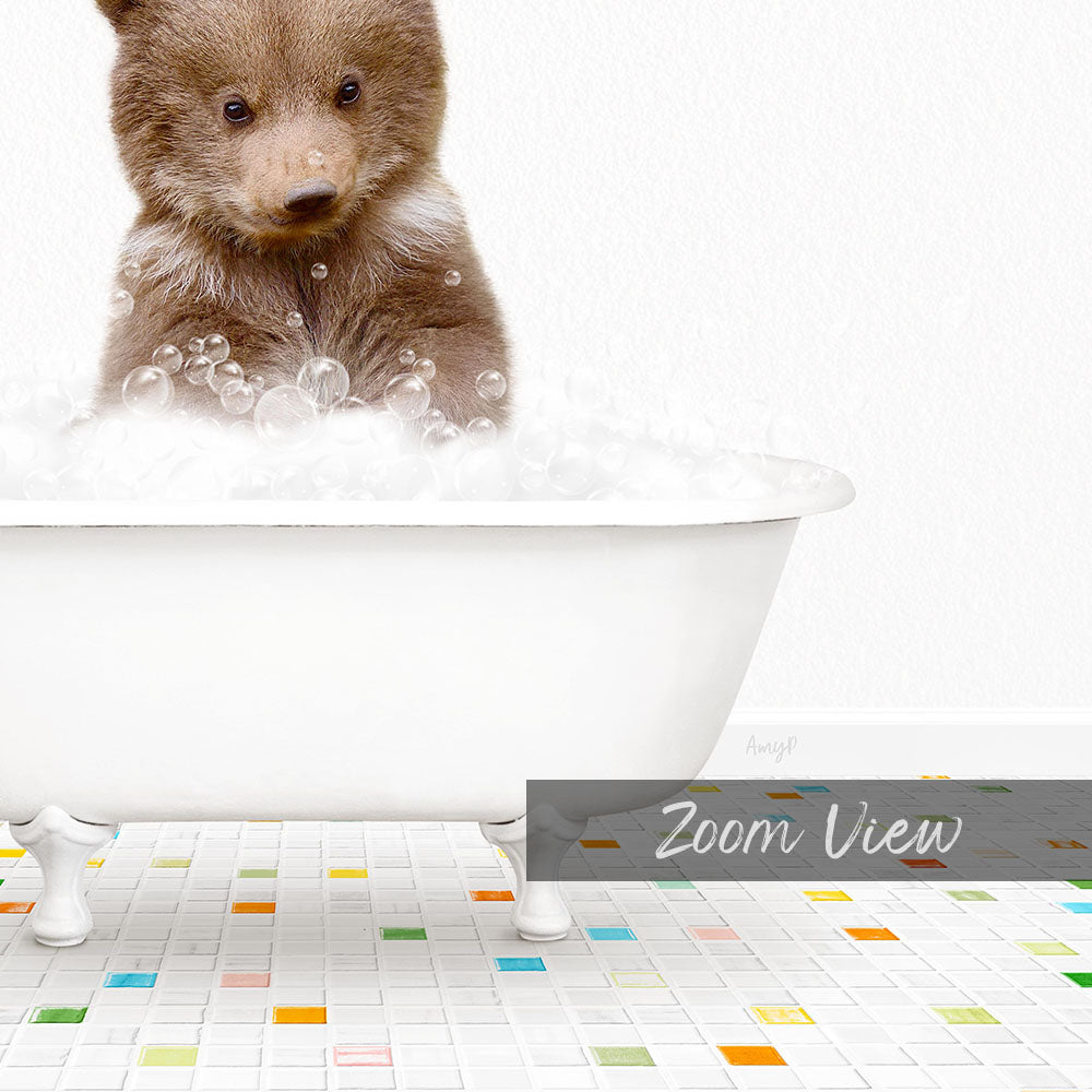 A cute brown bear cub sitting in a white bathtub filled with bubbles, surrounded by a colorful tiled floor.