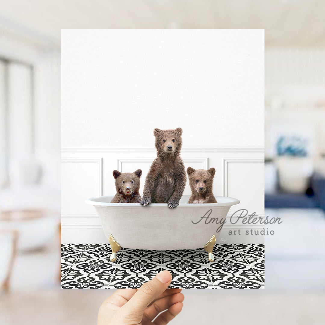 a person holding up a card with three bears in a bathtub