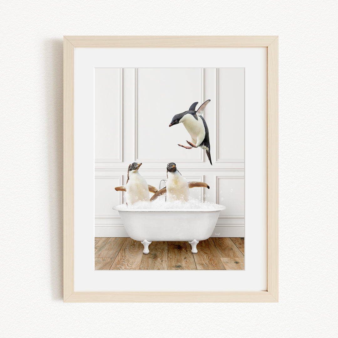A framed image depicting two penguins sitting in a bathtub, with one penguin flying towards the other.