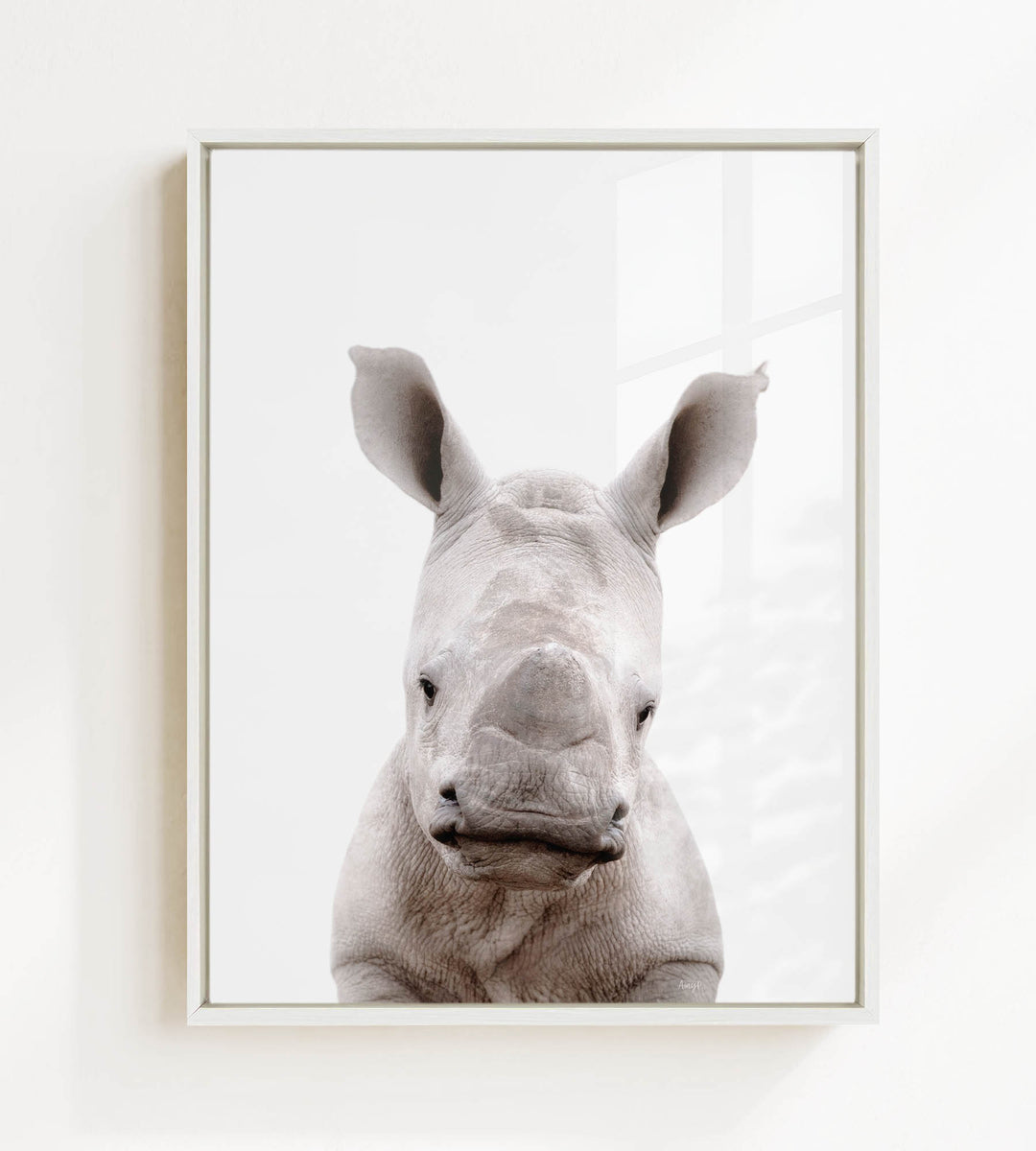 A close-up portrait of a rhinoceros, with its distinctive horn-like features prominently displayed.