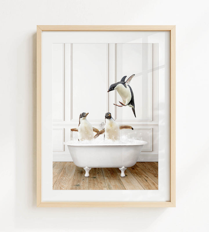 A framed image depicting two penguins sitting in a bathtub, with one penguin flying towards the other.