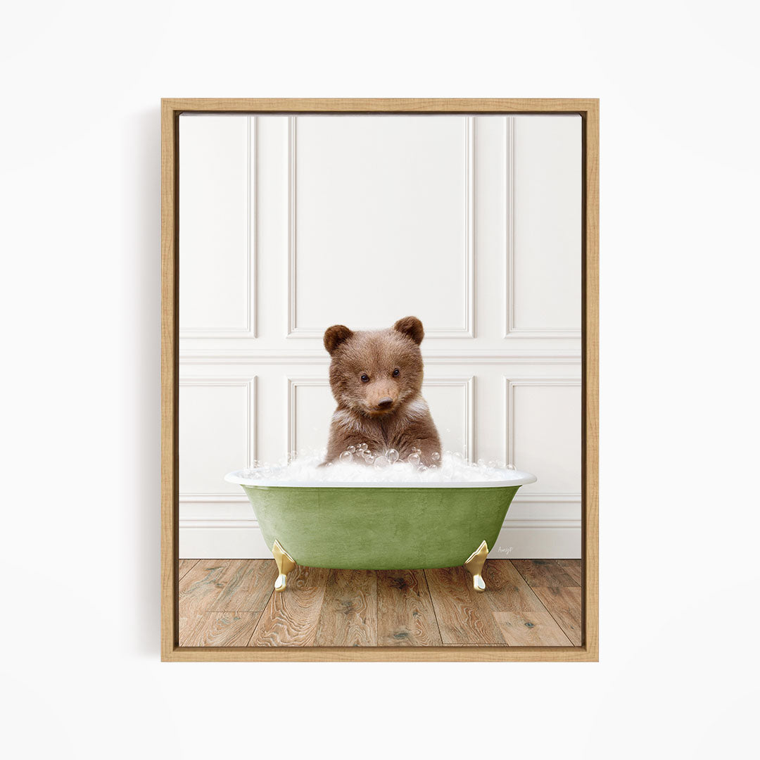 A brown bear sitting in a green bathtub filled with water, looking directly at the camera.
