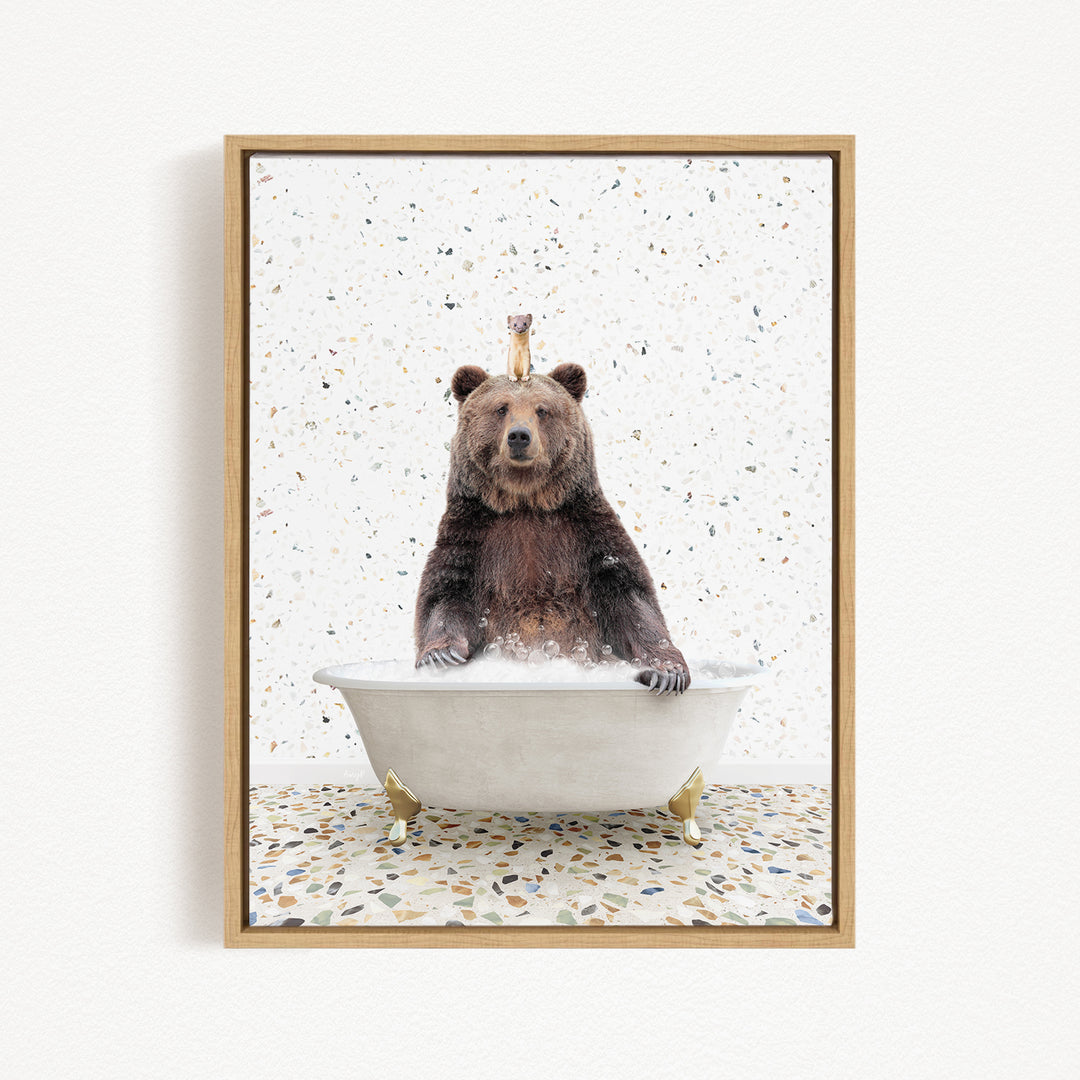 A brown bear sitting in a white bathtub filled with water, with a crown on its head, against a speckled white background.