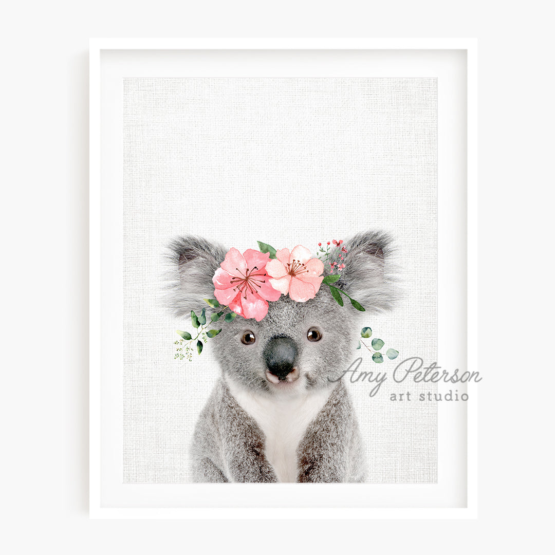 a picture of a koala with flowers on its head